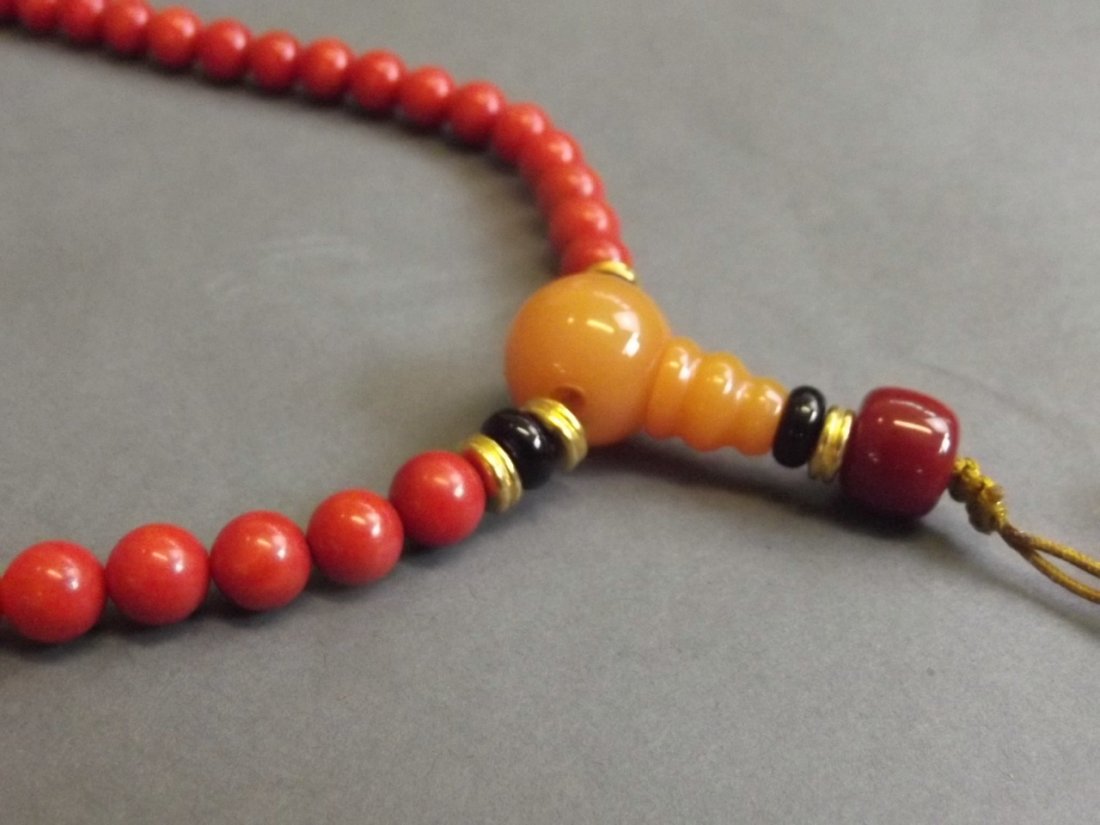 A Chinese beaded coral necklace with some semi-precious: A Chinese beaded coral necklace with some semi-precious stone beads, 31'' long