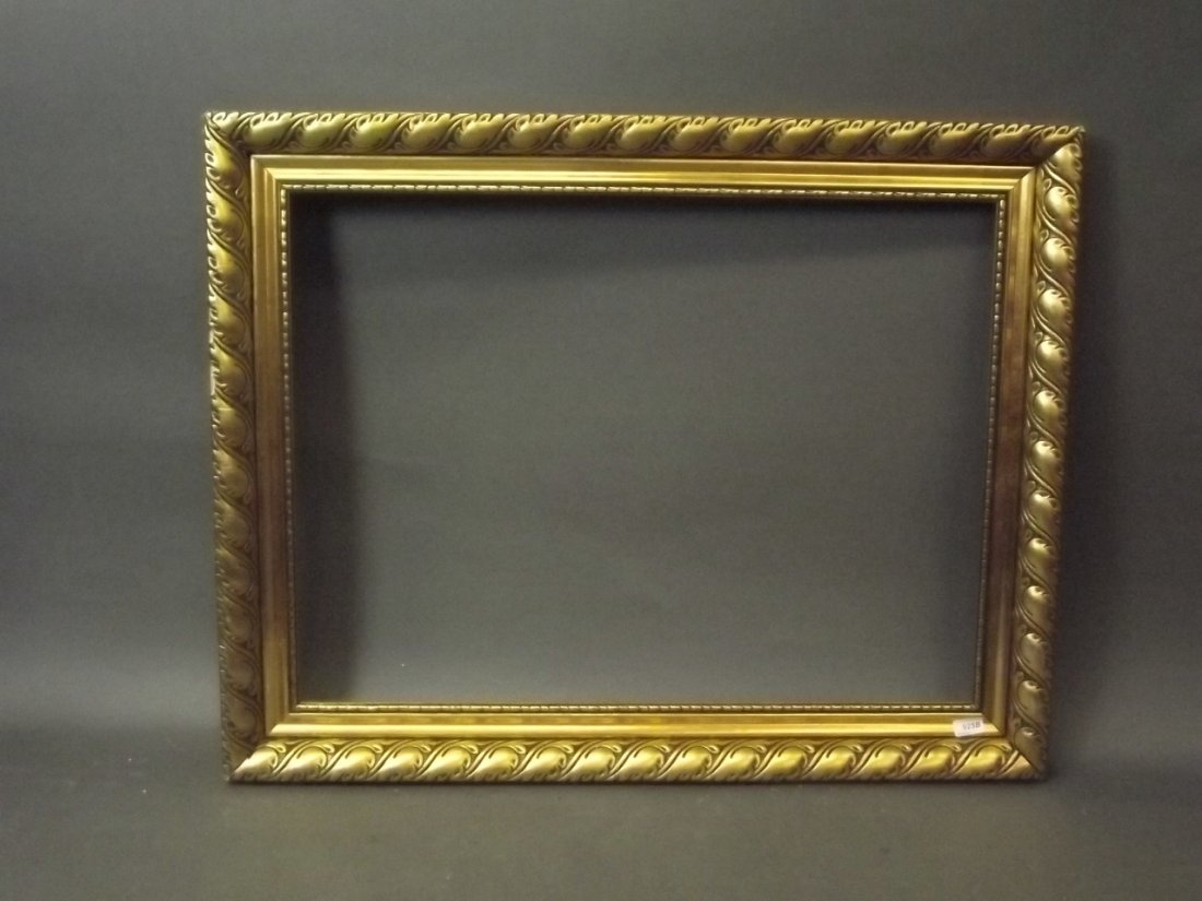 A late C19th Continental giltwood and composition frame: A late C19th Continental giltwood and composition frame with scrolled leaf decoration, rebate 34'' x 25¼''