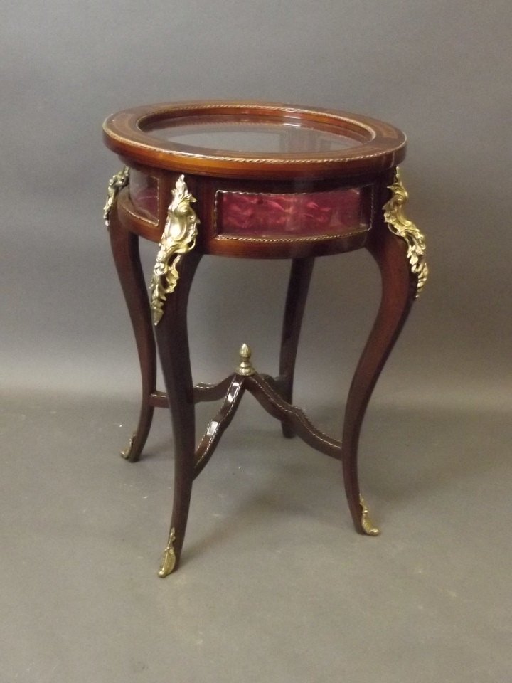 A bijouterie cabinet with tulip wood and marquetry: A bijouterie cabinet with tulip wood and marquetry inlaid decoration, with brass mounts,32'' high, 22'' diameter