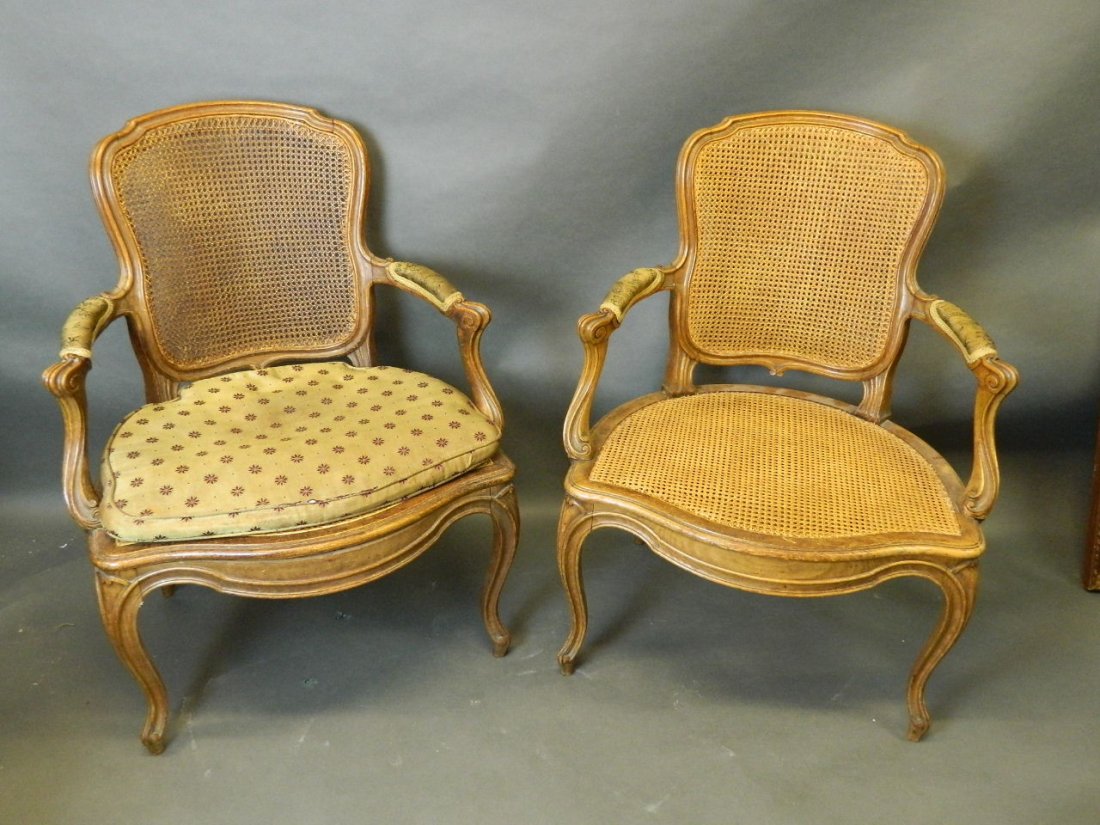 A pair of C19th French carved beech elbow chairs with: A pair of C19th French carved beech elbow chairs with serpentine shaped carved seats and shaped backs