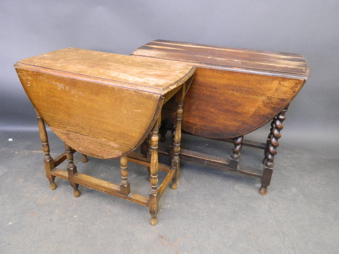 An oak drop leaf table with gateleg action and barley: An oak drop leaf table with gateleg action and barley twist legs, and another smaller, 28½'' high
