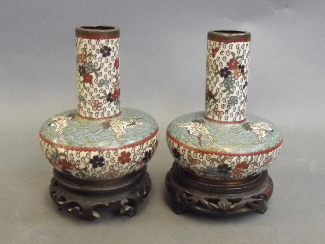 A pair of C19th Chinese cloisonné vases with floral and: A pair of C19th Chinese cloisonné vases with floral and stork decoration, on carved and pierced hardwood stands, 5½'' high
