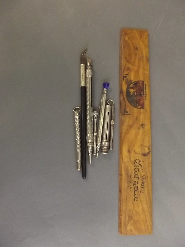 A wooden ruler and other writing implements, and lead: A wooden ruler and other writing implements, and lead holders, 11'' long