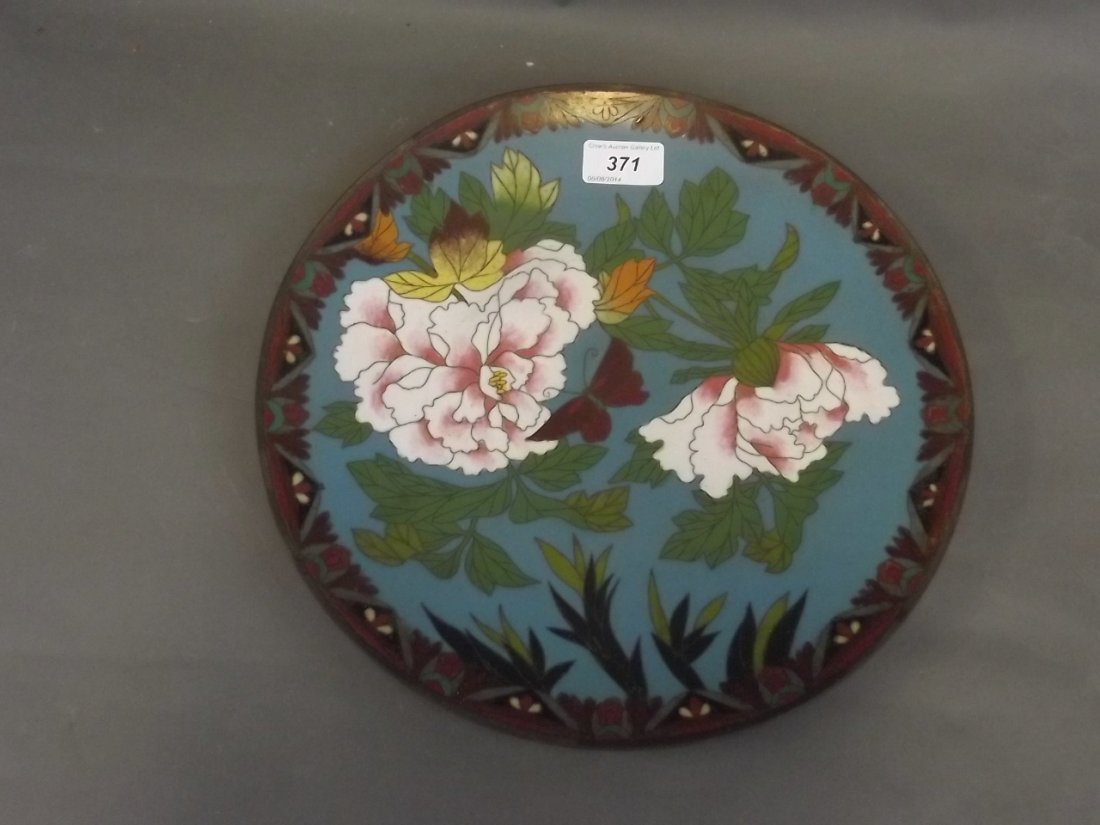 A C19th Japanese cloisonné charger decorated with: A C19th Japanese cloisonné charger decorated with flowers and a butterfly, 12'' diameter