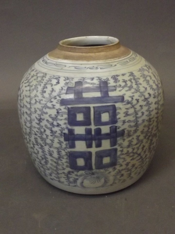 A Chinese bulbous blue and white porcelain jar with: A Chinese bulbous blue and white porcelain jar with scrolling vine, inscription and lotus flower decoration, 9'' high
