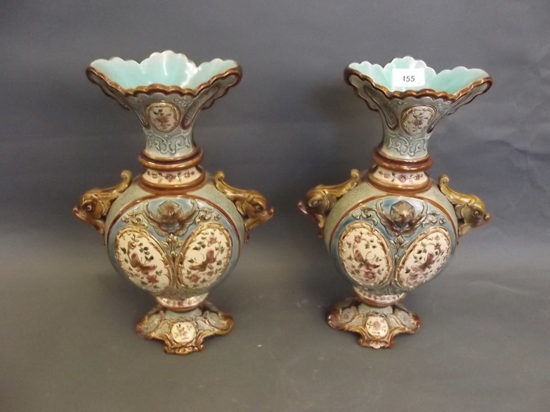 A large pair of twin handled Art Pottery vases: A large pair of twin handled Art Pottery vases decorated with raised butterfly and flower decoration, 15'' high (AF)