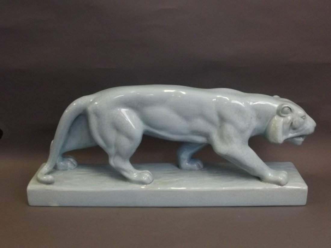 A large Art Pottery figure of a lioness with duck egg: A large Art Pottery figure of a lioness with duck egg blue ground, 26'' long