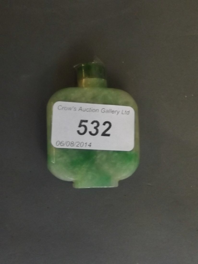 A Chinese jade mottled green carved snuff bottle and: A Chinese jade mottled green carved snuff bottle and stopper, 2¼'' high