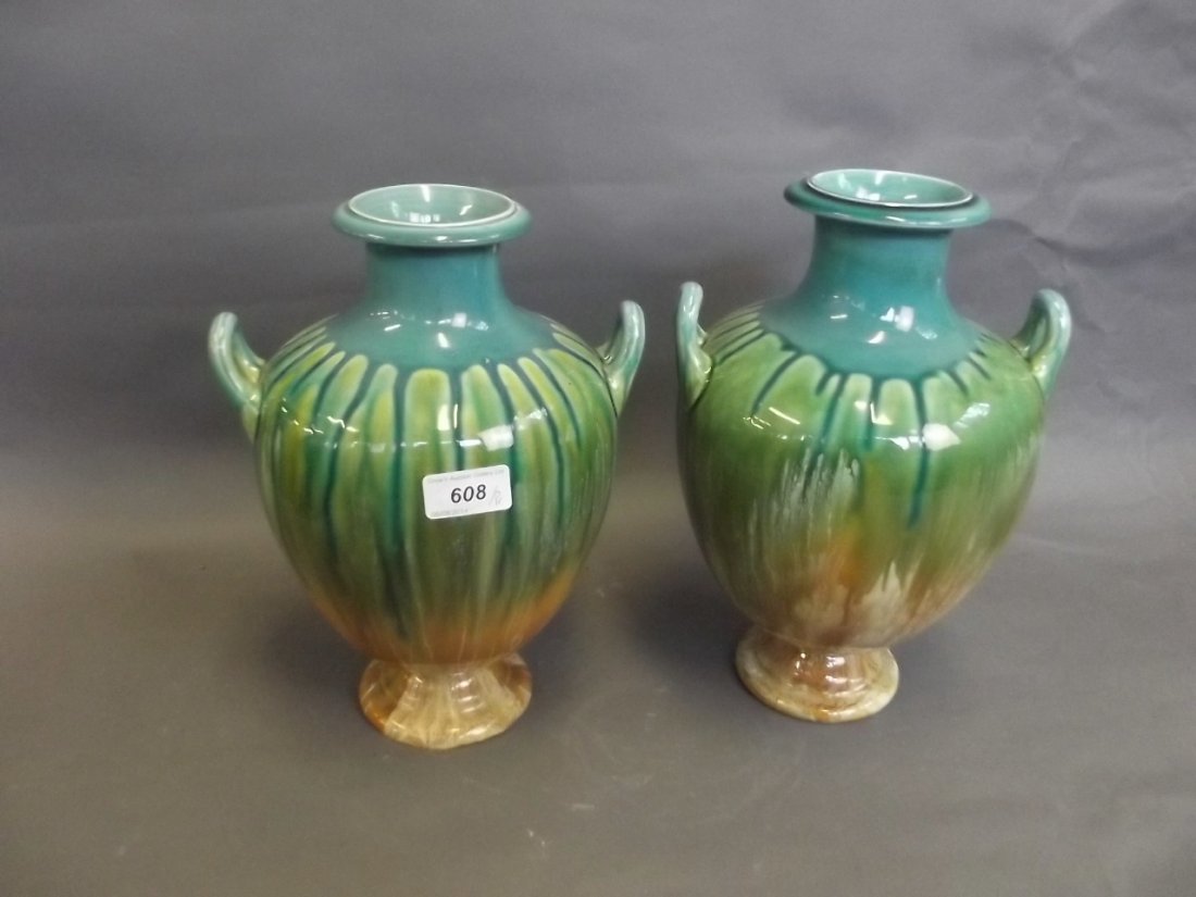 A large pair of late C19th twin handled pottery vases: A large pair of late C19th twin handled pottery vases with drip glazed decoration, possibly Linthorpe, 12¼'' high