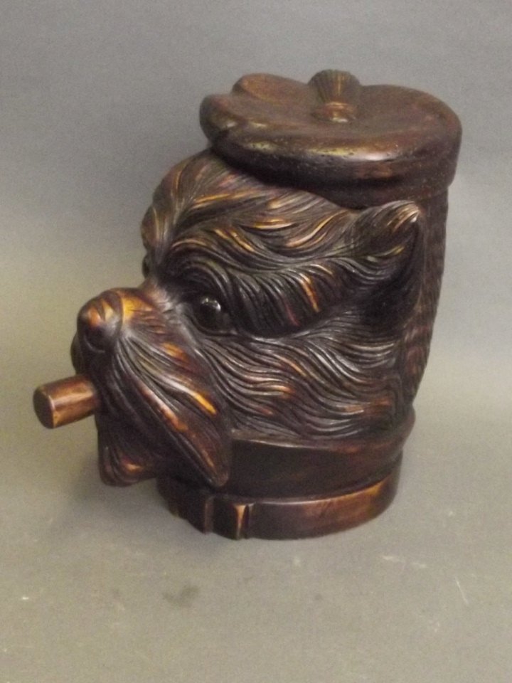 A Black Forest style tobacco jar in the form of a dog: A Black Forest style tobacco jar in the form of a dog wearing a beret, 7'' high