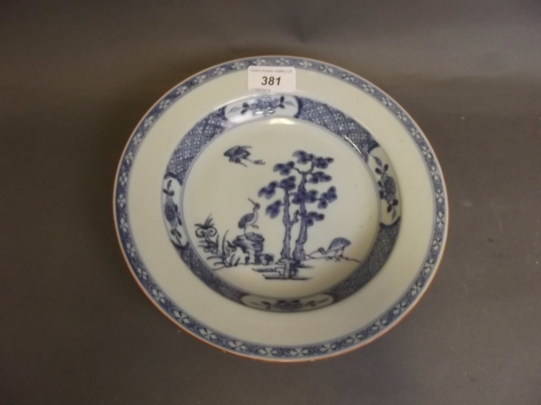 An early C19th Chinese blue and white dish painted with: An early C19th Chinese blue and white dish painted with birds and prunus trees, 9'' diameter