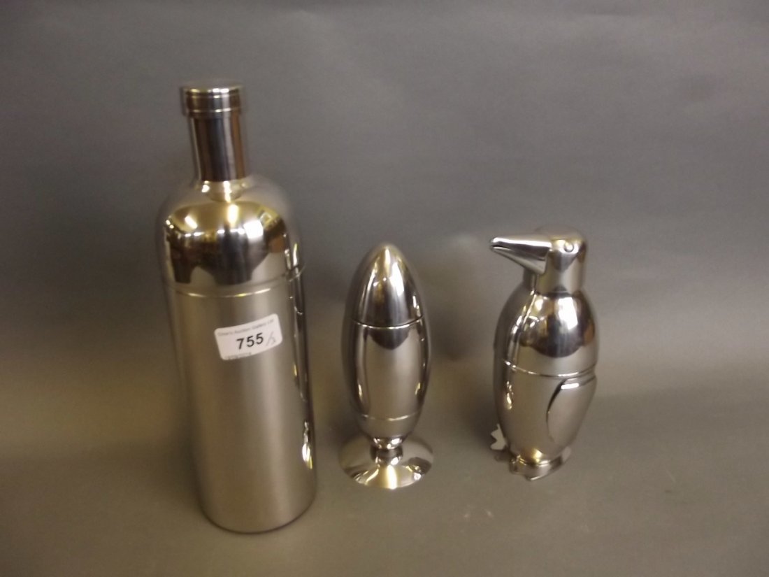 Three silver plated novelty cocktail shakers in the: Three silver plated novelty cocktail shakers in the form of a penguin, wine bottle and egg cup, largest 11½'' high
