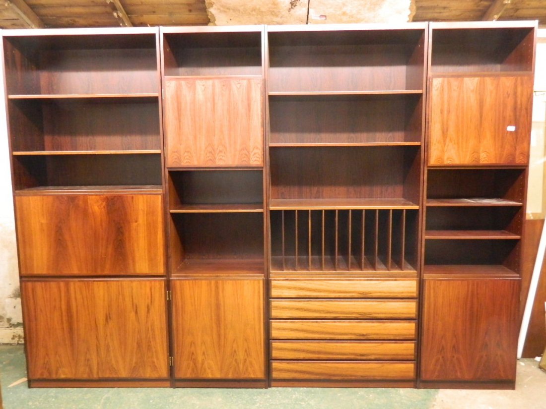 A 1970's Danish rosewood four section cabinet by: A 1970's Danish rosewood four section cabinet by Scan-Flex fitted with drawers and cupboards, 84'' high, 116'' wide, 16'' deep