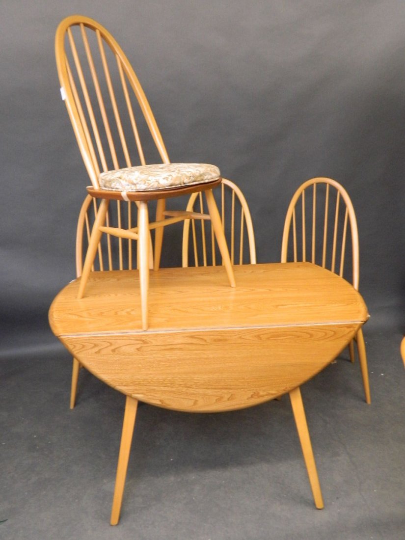 An Ercol circular dining table and four matching: An Ercol circular dining table and four matching chairs, 44'' diameter