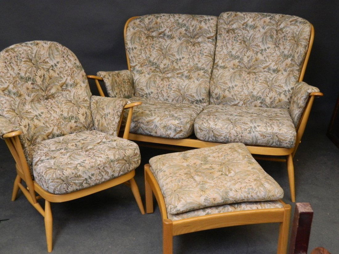 An Ercol three piece cottage suite comprising a settee,: An Ercol three piece cottage suite comprising a settee, armchair and a stool