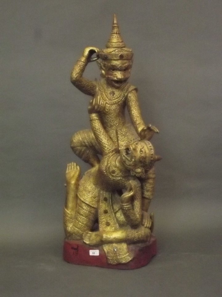 A large Thai giltwood carving of two fighting monkeys,: A large Thai giltwood carving of two fighting monkeys, the whole inset with coloured glass, possibly C20th, 39'' high