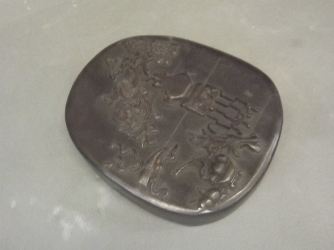 A Chinese ink palette with inscription, set within a: A Chinese ink palette with inscription, set within a hardwood case with carved decoration depicting a vase on stand, 9'' long