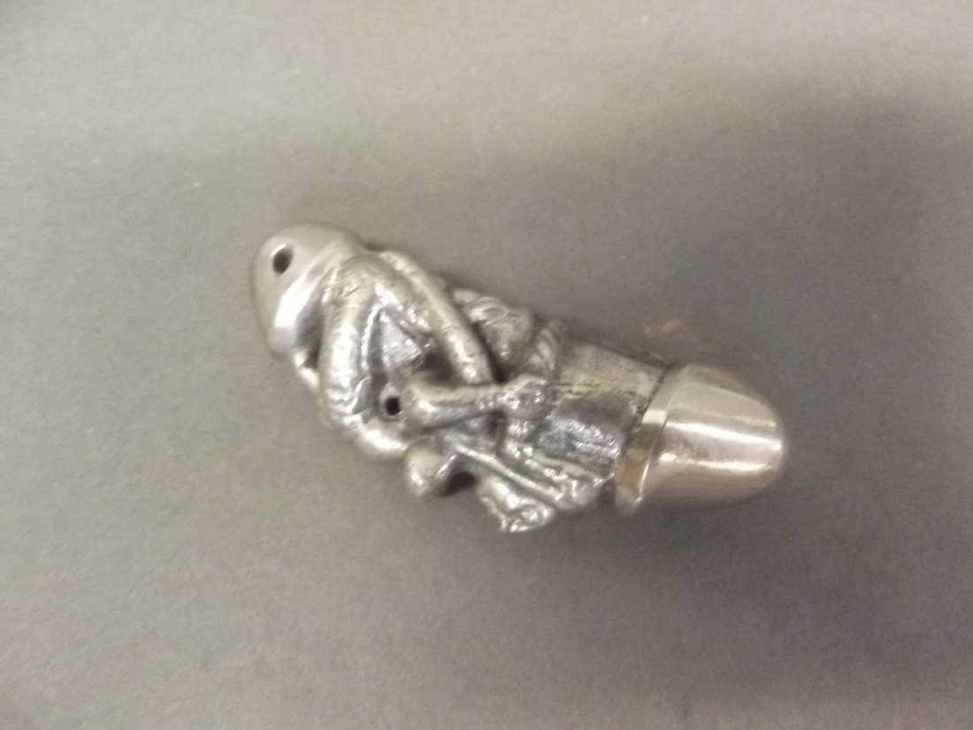 A white metal netsuke decorated with an erotic scene,: A white metal netsuke decorated with an erotic scene, 2½'' long