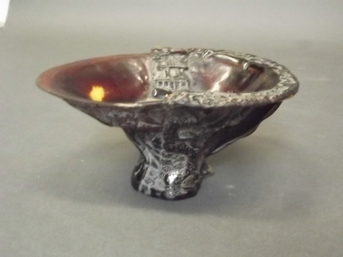 A Chinese horn libation cup with carved decoration, 8'': A Chinese horn libation cup with carved decoration, 8'' long, 4'' high