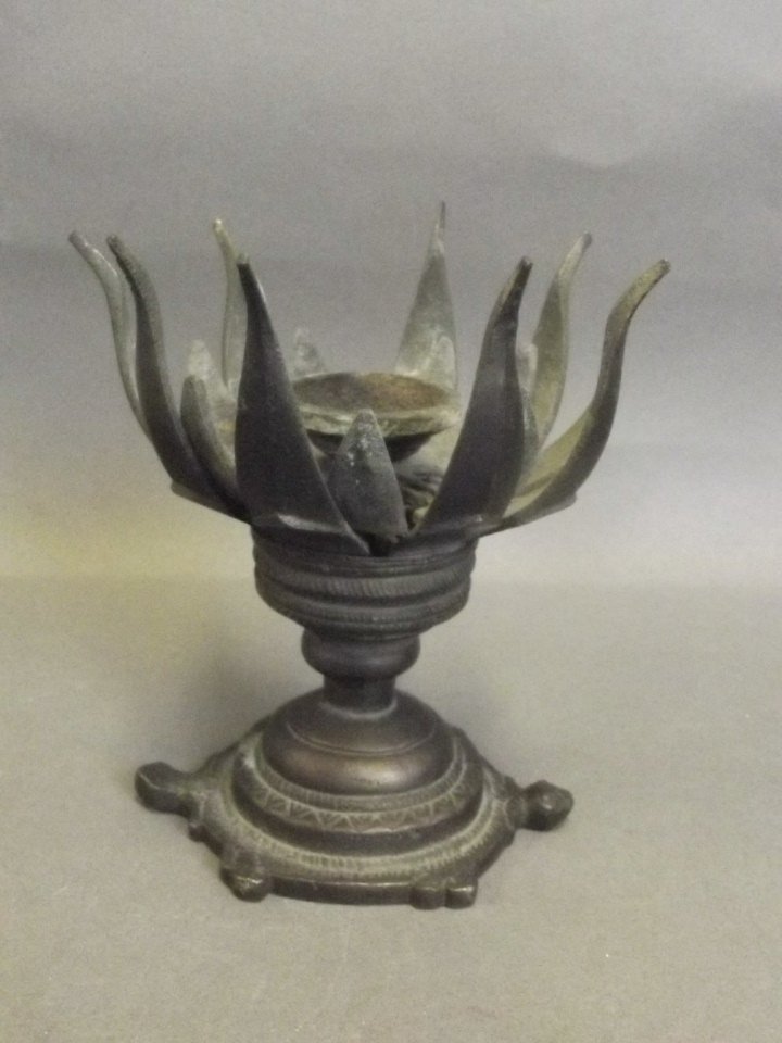 A C19th Chinese bronze incense burner in the form of a: A C19th Chinese bronze incense burner in the form of a stylised lotus flower upon a tortoise's back, the leaves folding out to reveal the burner, 4½'' high