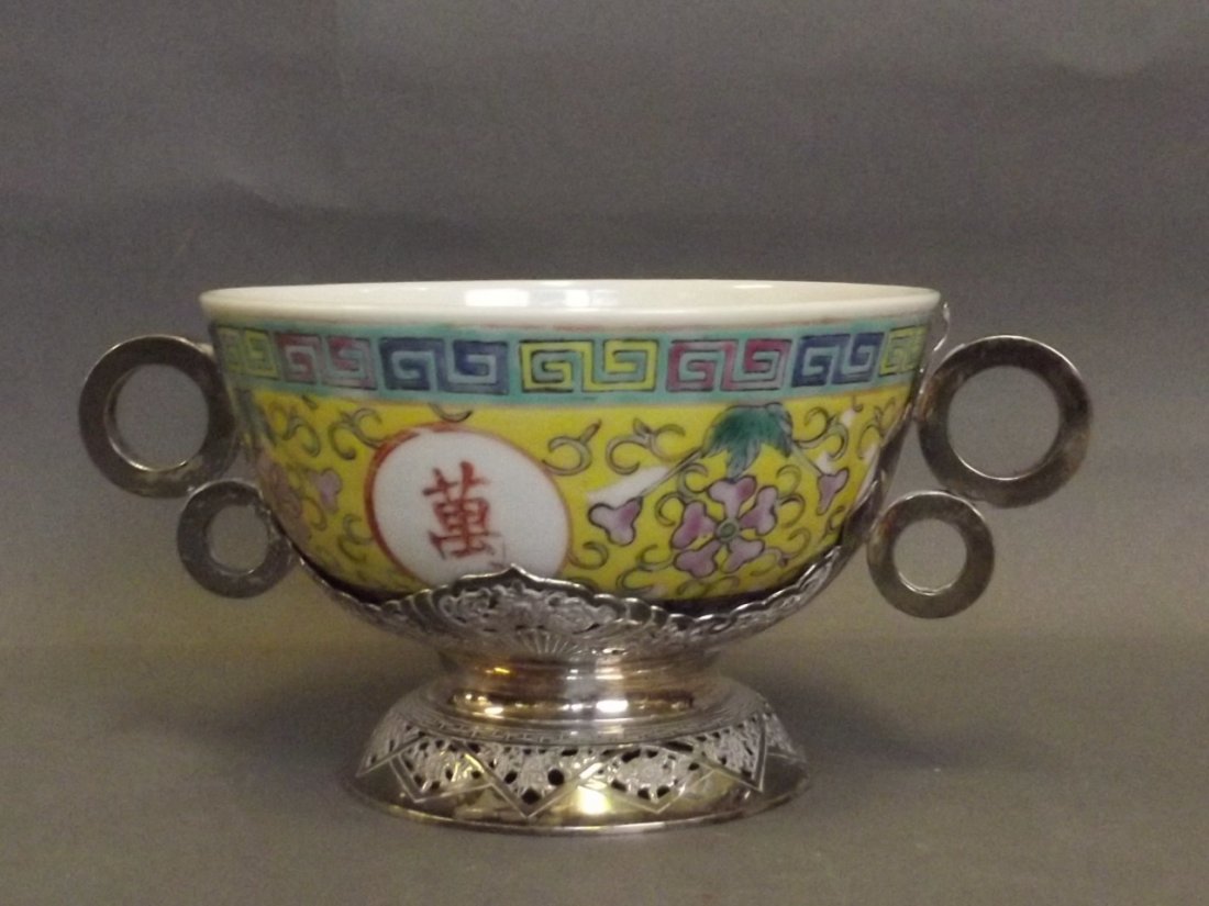 A Chinese yellow ground rice bowl mounted in a pierced: A Chinese yellow ground rice bowl mounted in a pierced silver plated stand, 4½'' diameter