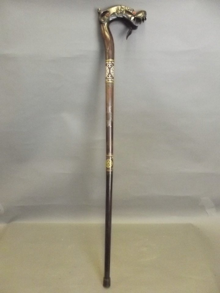 A Chinese walking stick with silver and cloisonné: A Chinese walking stick with silver and cloisonné enamel inlaid decoration, and a carved handle in the form of a dragon's head, 36'' long