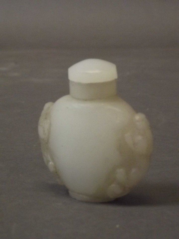 A Chinese white jade scent bottle with carved kylin: A Chinese white jade scent bottle with carved kylin handles, 2¼'' high