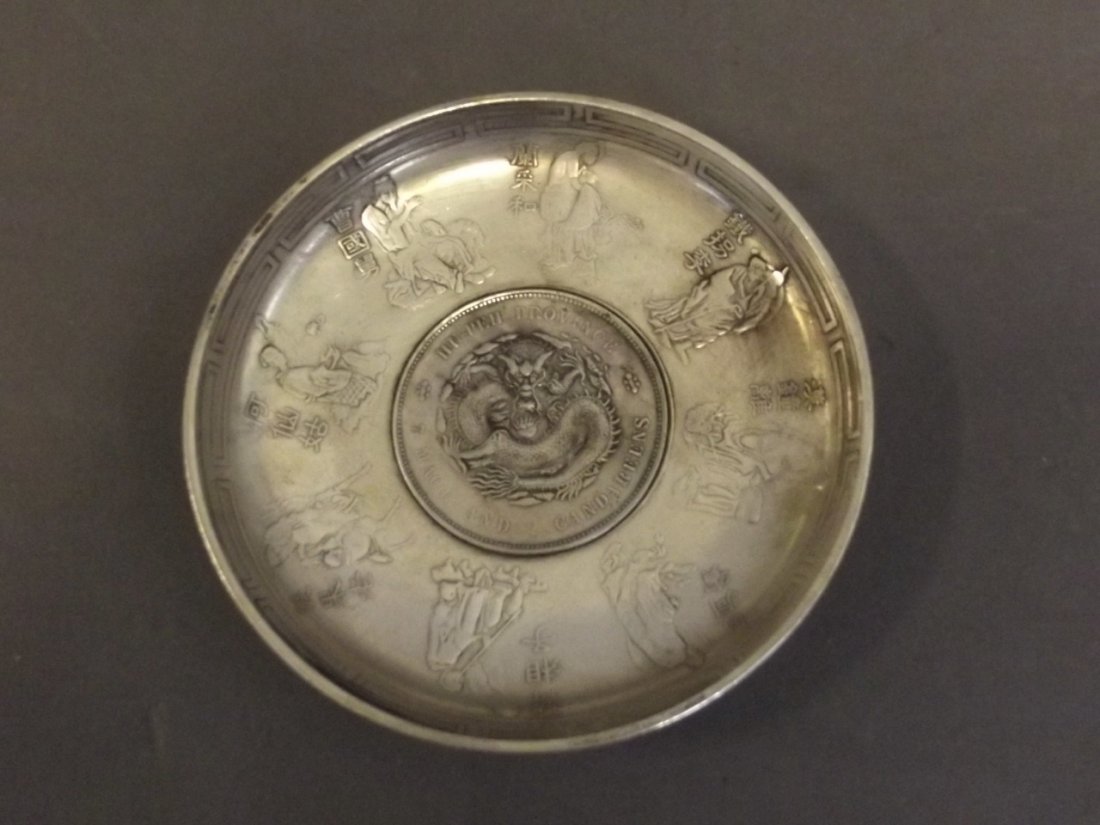 A Chinese silver dish decorated with a dragon coin,: A Chinese silver dish decorated with a dragon coin, from Hu-Pen Province, 3½'' diameter