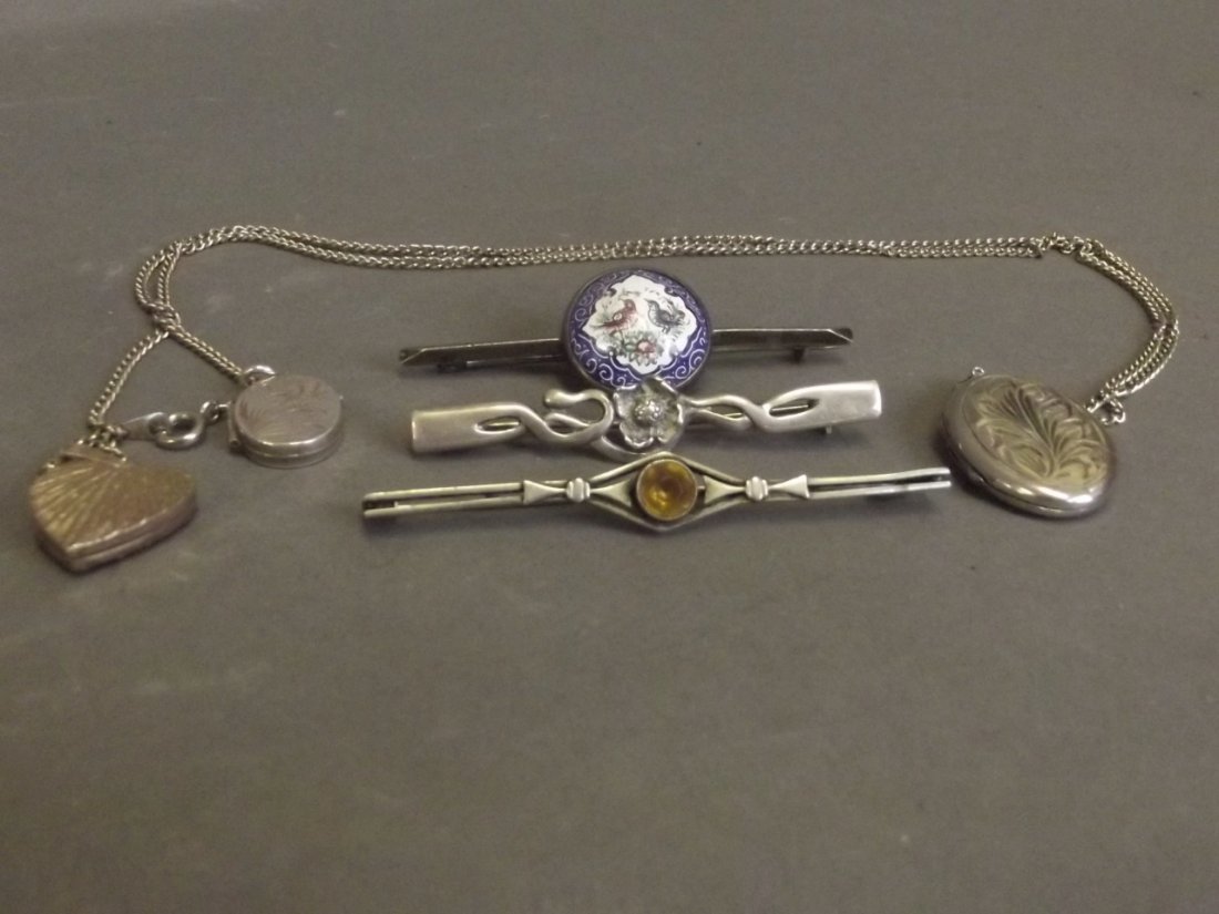 Three unmarked silver lockets and three bar brooches: Three unmarked silver lockets and three bar brooches