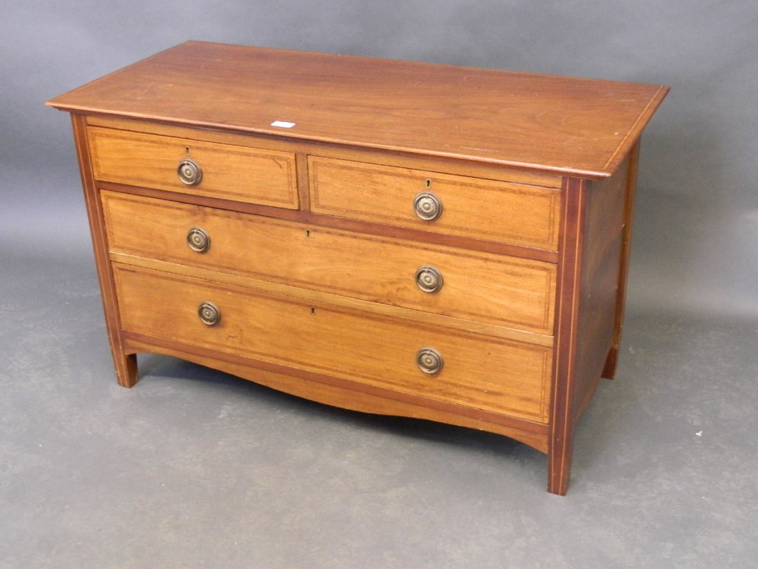 An Edwardian inlaid mahogany low chest of two short and: An Edwardian inlaid mahogany low chest of two short and 2 long drawers, 42'' wide, 19'' deep, 25'' high