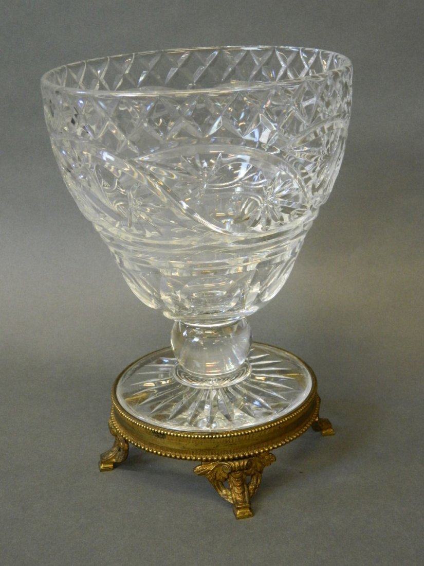 A large cut glass stem bowl on brass mounts, 9½'' high: A large cut glass stem bowl on brass mounts, 9½'' high