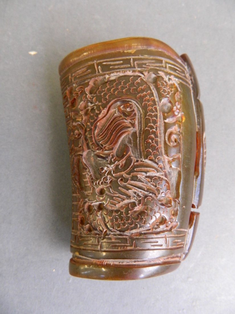 A Chinese horn libation cup carved with dragons, 4'': A Chinese horn libation cup carved with dragons, 4'' high