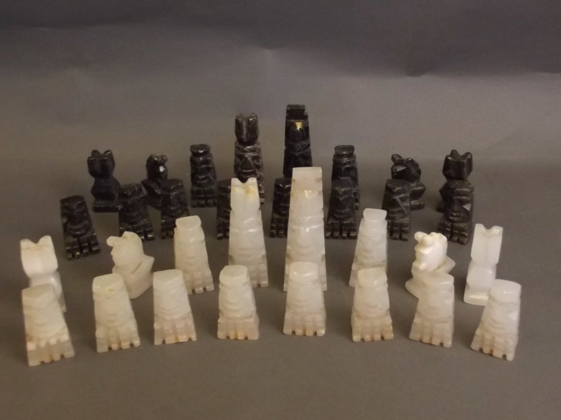 A carved stone Mexican chess set labelled 'Hecho En: A carved stone Mexican chess set labelled 'Hecho En Mexico', 4'' high
