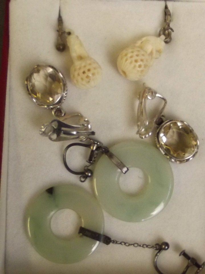 A pair of silver and jade pi-shaped earrings, a pair of: A pair of silver and jade pi-shaped earrings, a pair of citrine earrings, and a pair of carved bone earrings in the form of elephants on a pierced ball