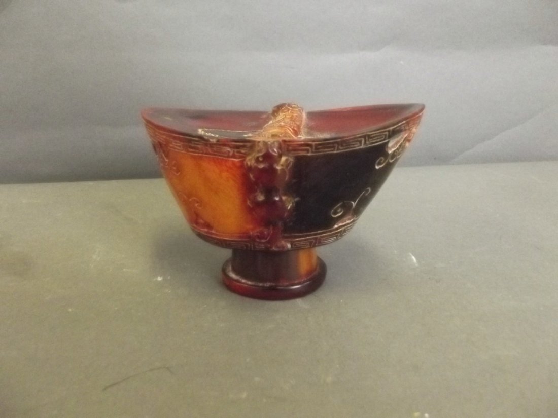 A Chinese ornamental horn cup with carved kylin and: A Chinese ornamental horn cup with carved kylin and tree decoration, 4 character mark, 3'' high