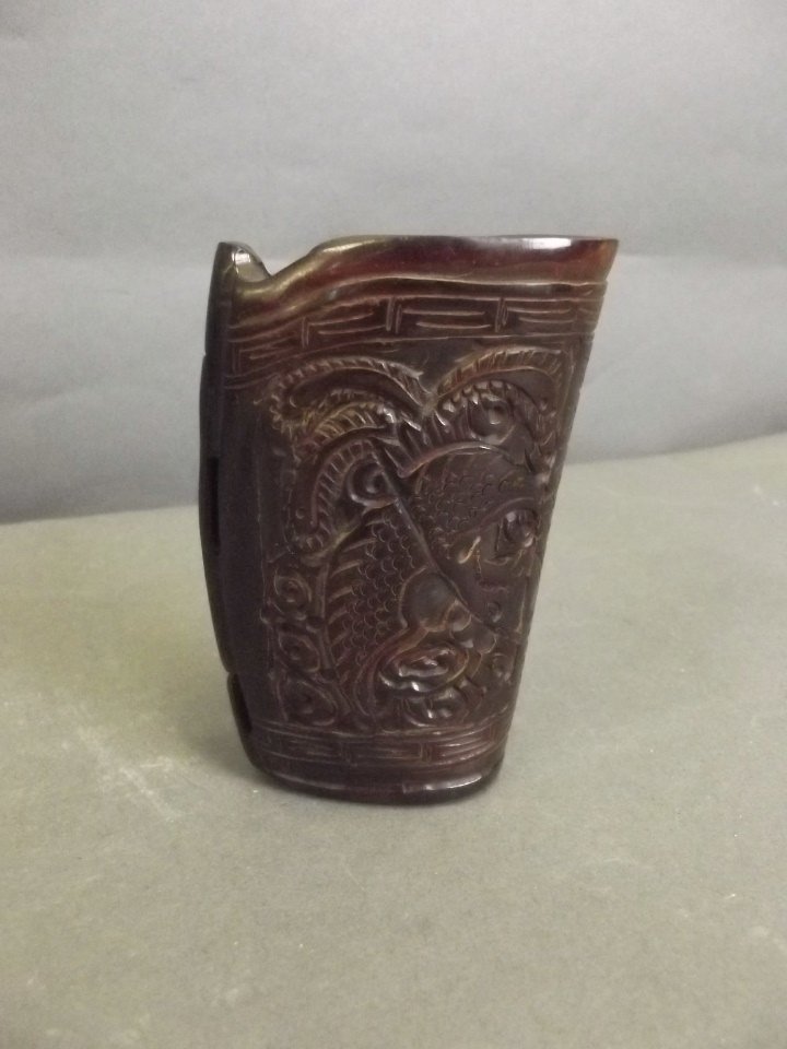 A Chinese carved horn cup with dragon and phoenix: A Chinese carved horn cup with dragon and phoenix decoration, 4'' high