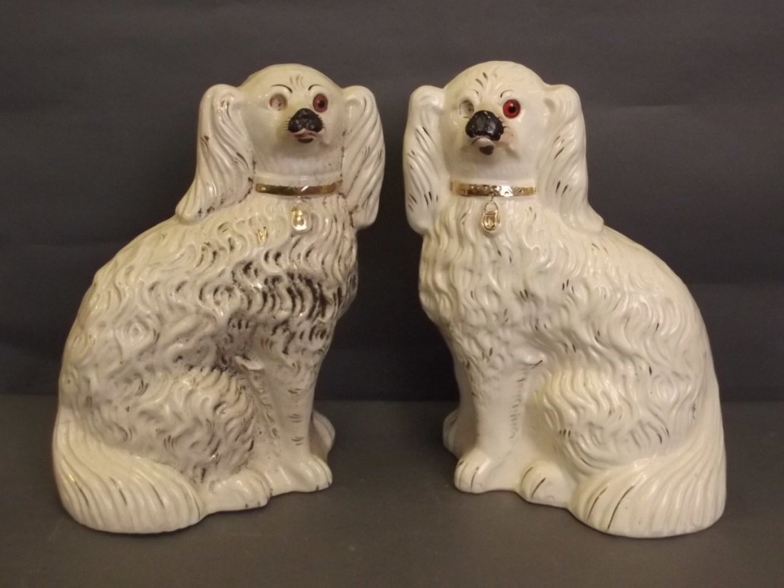 A pair of large white and gilt Staffordshire figures of: A pair of large white and gilt Staffordshire figures of dogs with inset glass eyes, 12½'' high