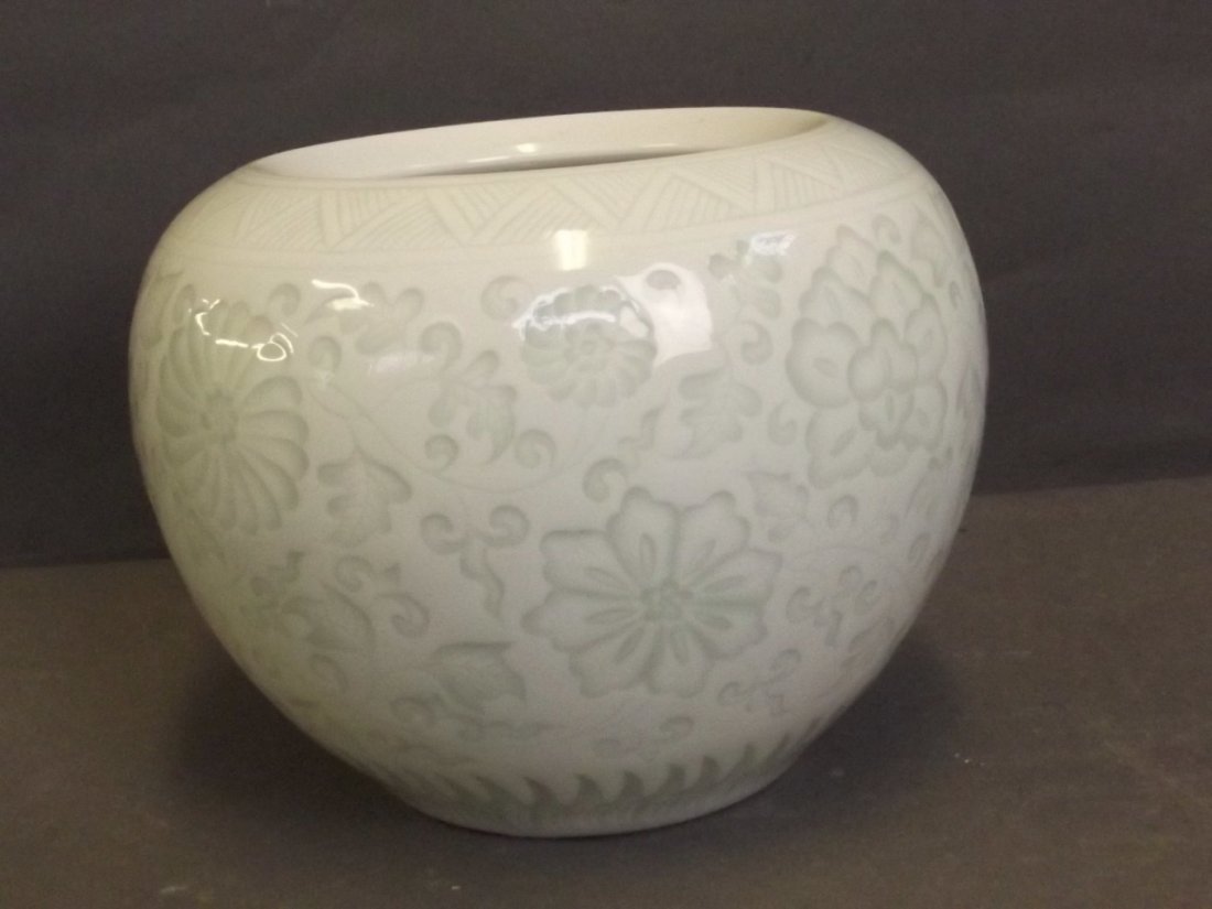 A celadon jar with floral decoration, printed mark,: A celadon jar with floral decoration, printed mark, 4½'' high