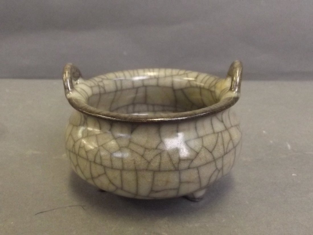 A small Chinese crackle glazed twin handled porcelain: A small Chinese crackle glazed twin handled porcelain censer on tripod supports, 3¼'' diameter