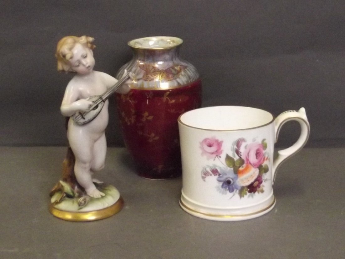 A Lustre vase decorated with butterflies, marked 'KPM',: A Lustre vase decorated with butterflies, marked 'KPM', a Davenport mug painted with flowers, and a Continental figure of a cherub, 6'' high