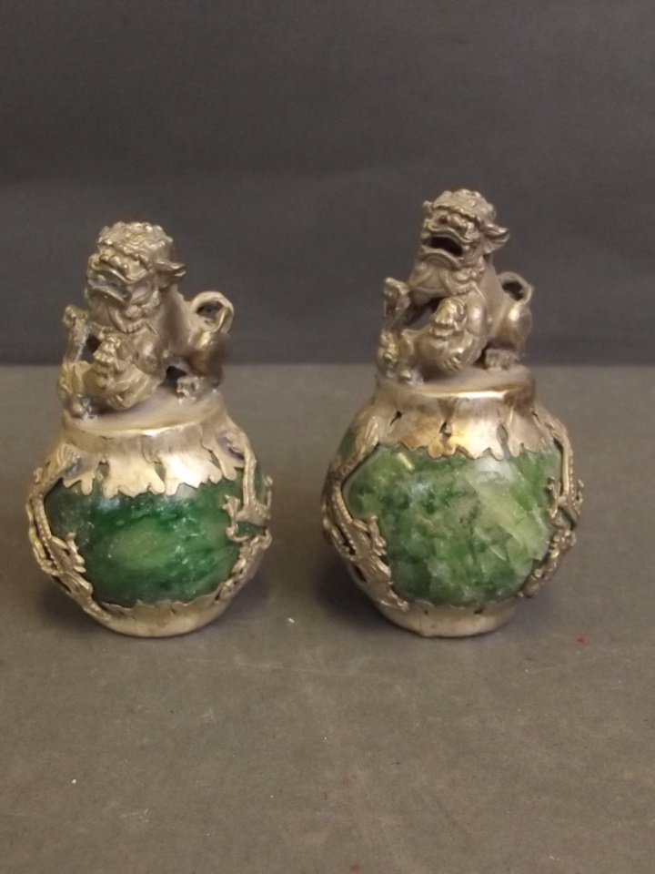 A pair of Chinese white metal and malachite ornaments: A pair of Chinese white metal and malachite ornaments with Fo dog surmounts, 2¾'' high