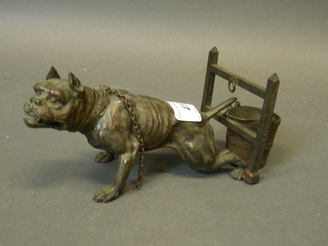 A bronze figure of a bulldog tied to a gate, 8'' x 3½'': A bronze figure of a bulldog tied to a gate, 8'' x 3½''
