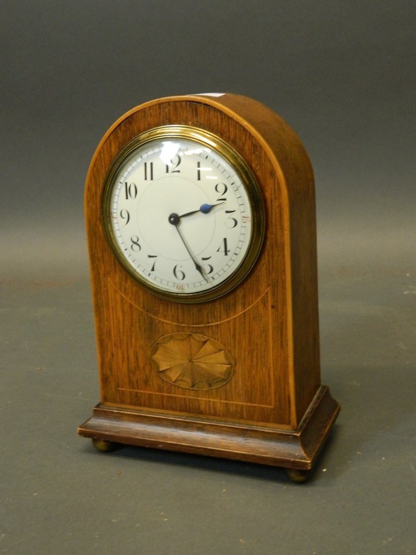 An early C20th small oak mantle clock with marquetry: An early C20th small oak mantle clock with marquetry inlaid decoration and enamel dial, 8½'' high