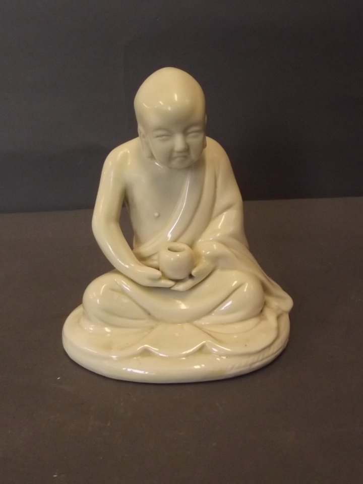 A Chinese blanc-de-chine figure of a seated Buddha,: A Chinese blanc-de-chine figure of a seated Buddha, impressed mark verso, 4½'' high