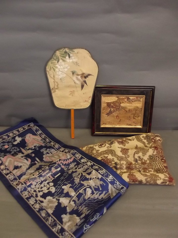 Three Oriental embroideries, and a fan decorated with a: Three Oriental embroideries, and a fan decorated with a bird, 15'' long