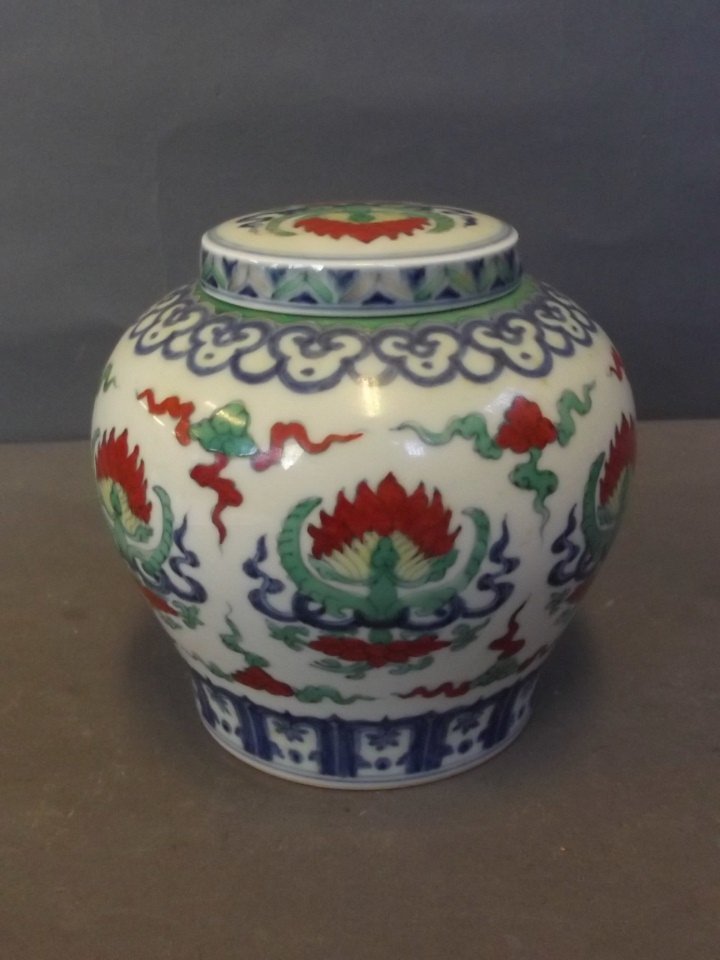 A Chinese porcelain Doucai jar and cover with stylised: A Chinese porcelain Doucai jar and cover with stylised lotus decoration, signed, 4½'' high