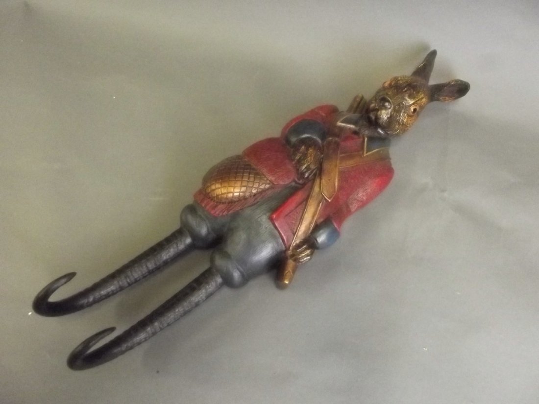 A painted composition coat hook in the form of a: A painted composition coat hook in the form of a hunting hare, 19'' long