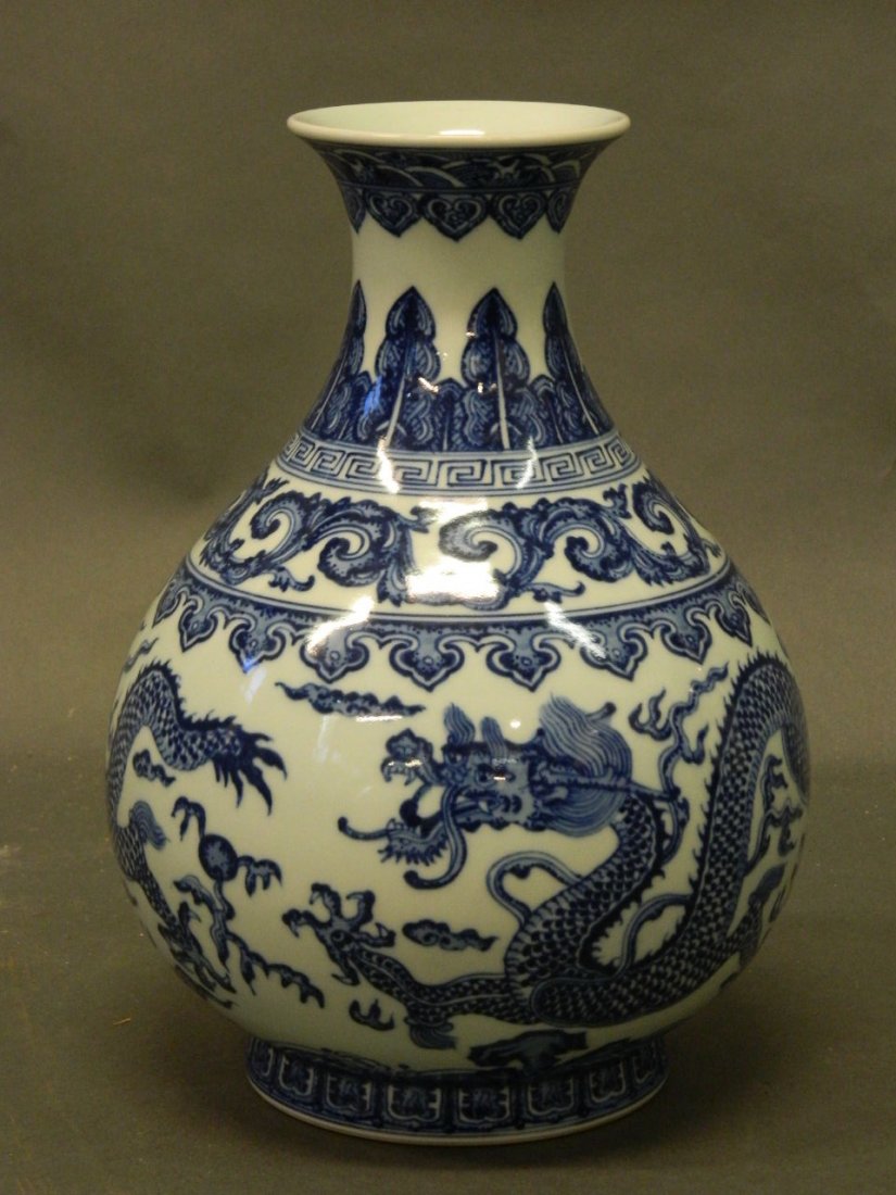 A Chinese baluster shaped porcelain vase with dragon: A Chinese baluster shaped porcelain vase with dragon and scrolled decoration in the blue and white palette, seal mark, 10½'' high