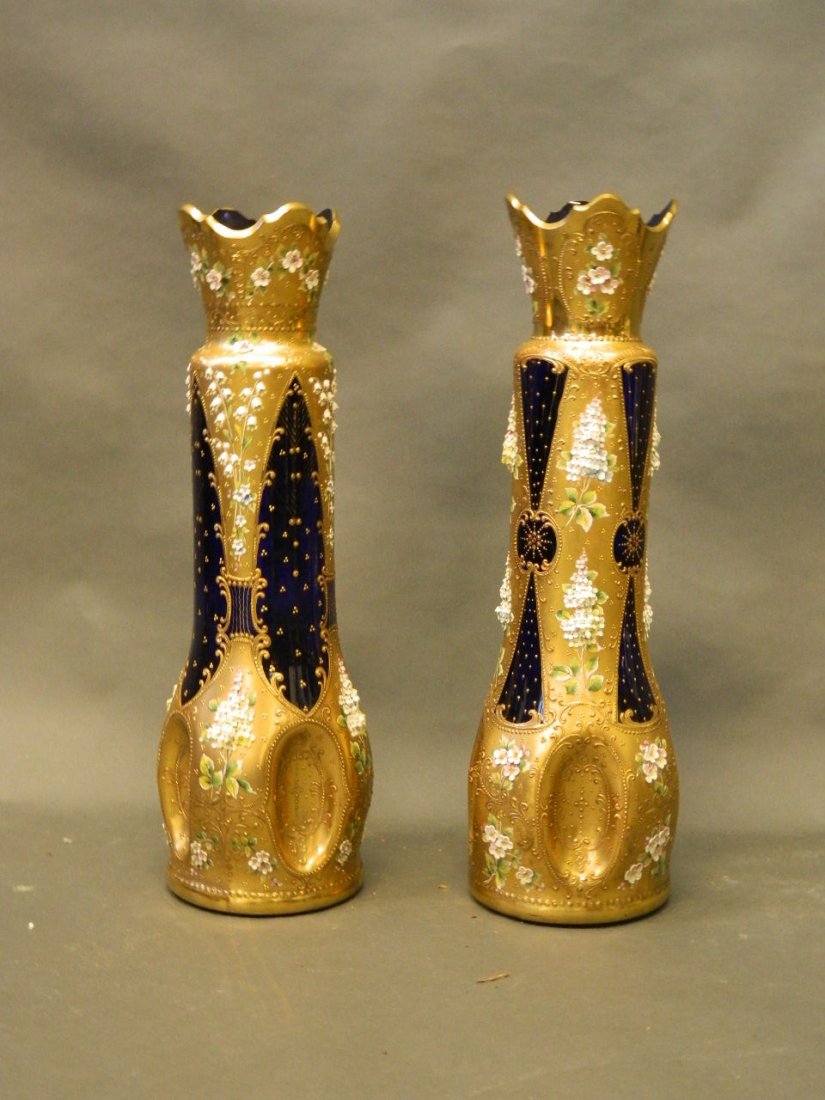 A large near pair of Bohemian blue glass vases, with: A large near pair of Bohemian blue glass vases, with gilt and overlaid floral decoration, 22½'' high