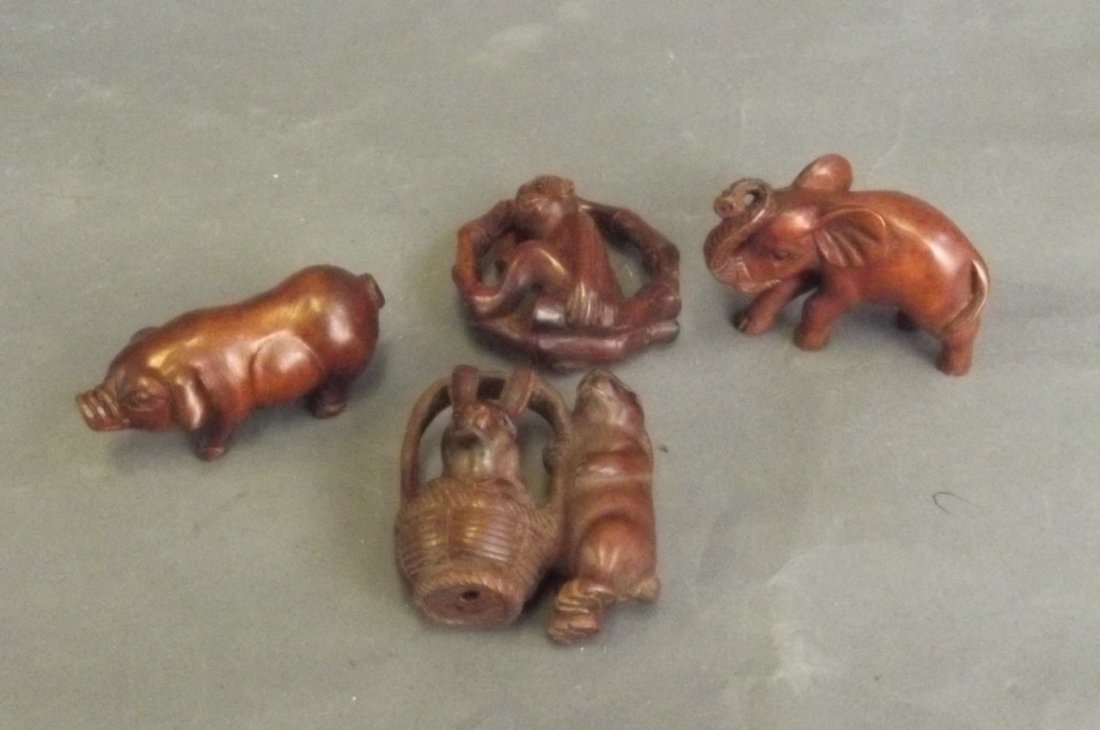 Four Chinese wooden netsuke in the form of a pig,: Four Chinese wooden netsuke in the form of a pig, elephant, rabbits, and a monkey, 2'' high